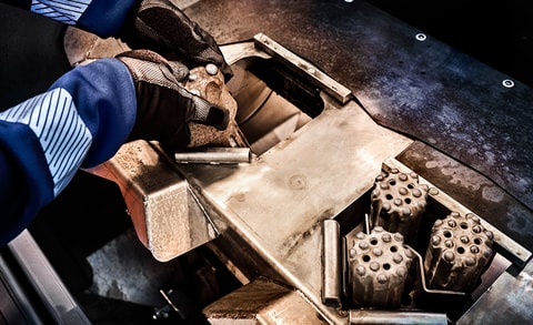 Grinding placed bits in machine