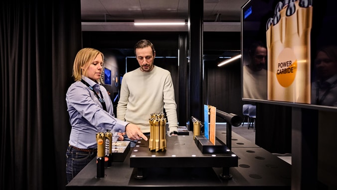 Two people in Rock Tools experience center