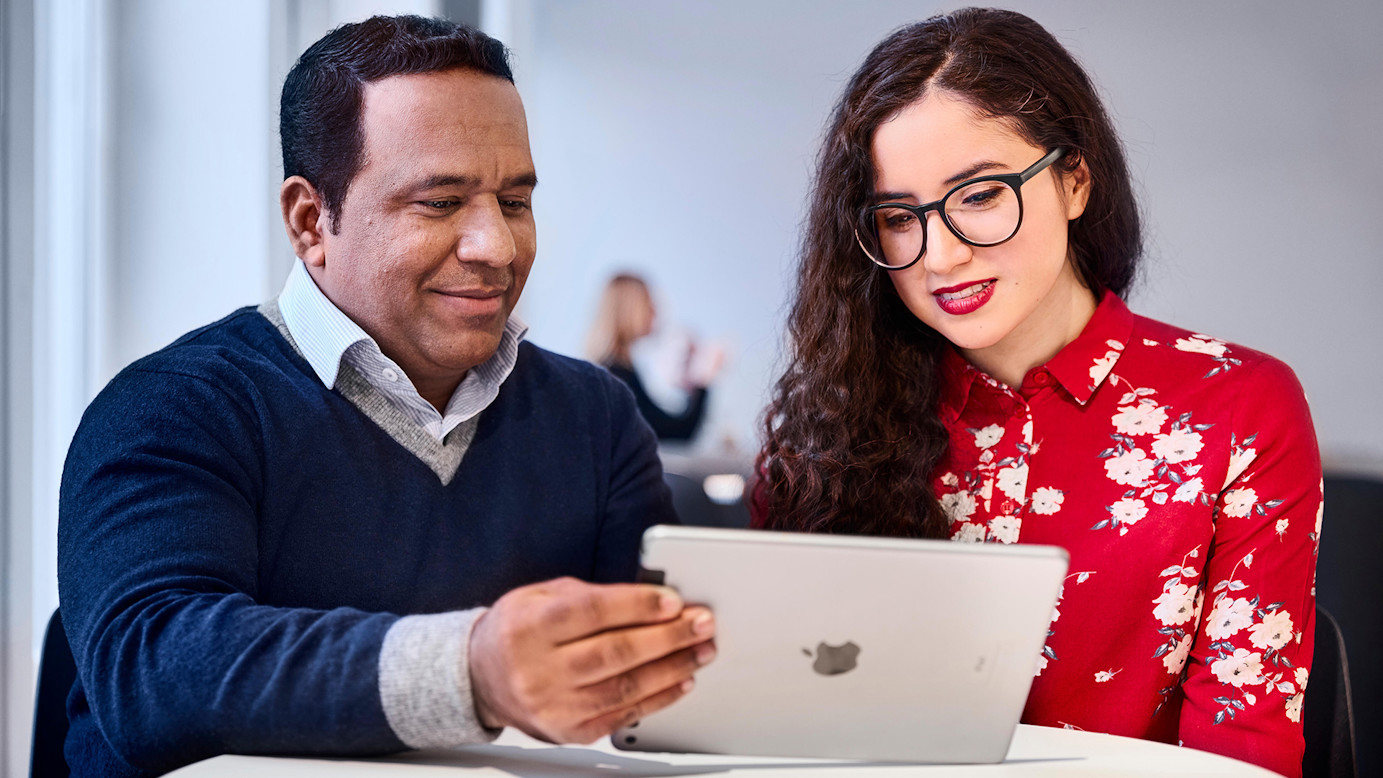 Two people looking at iPad