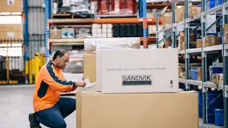 Person in warehouse with parts
